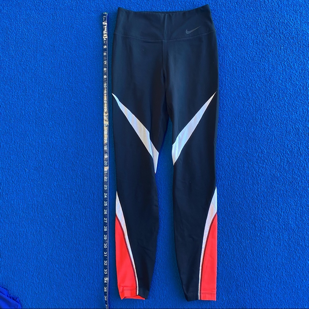 Red and black Nike leggings with white mesh detail
